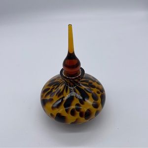Glass perfume bottle with stopper. Leopard print